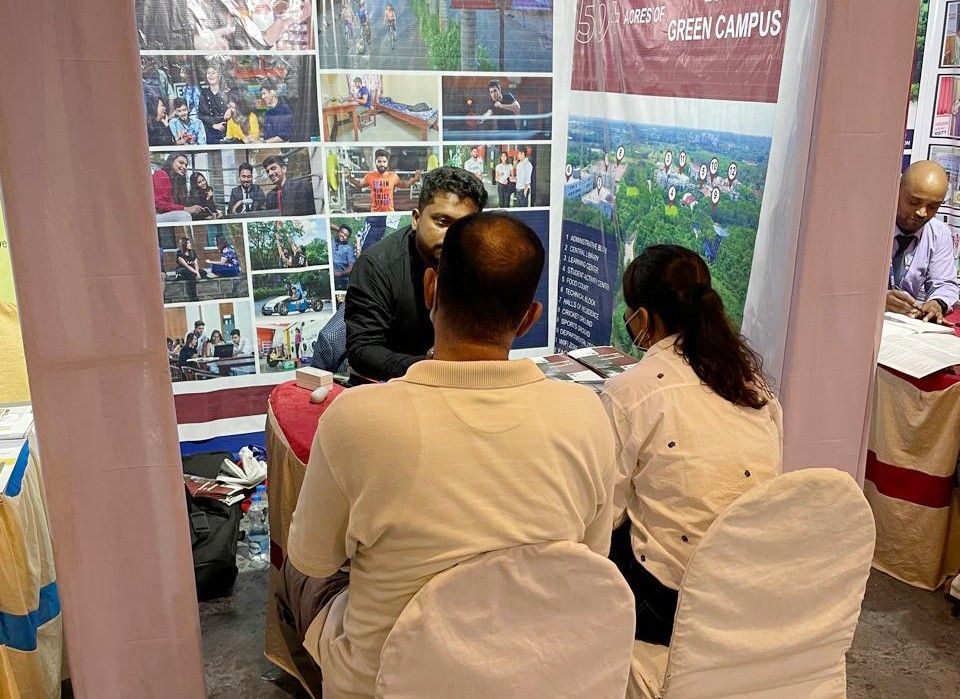 Students posing with mentors at the fair