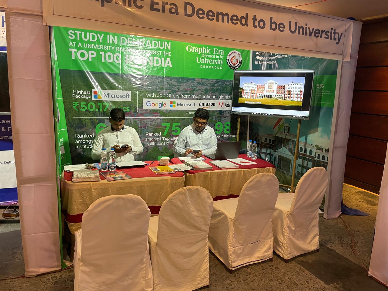 Families visiting a busy education fair floor