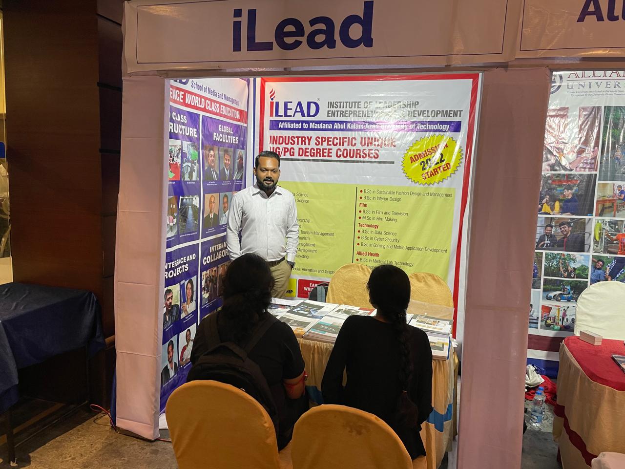 Counselor guiding students through course brochures