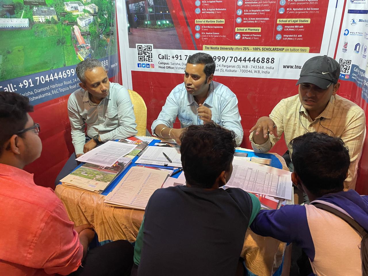 Counselor guiding students through course brochures