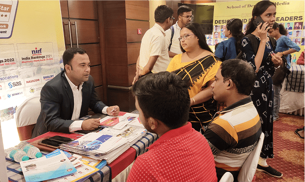 Students posing with mentors at the fair
